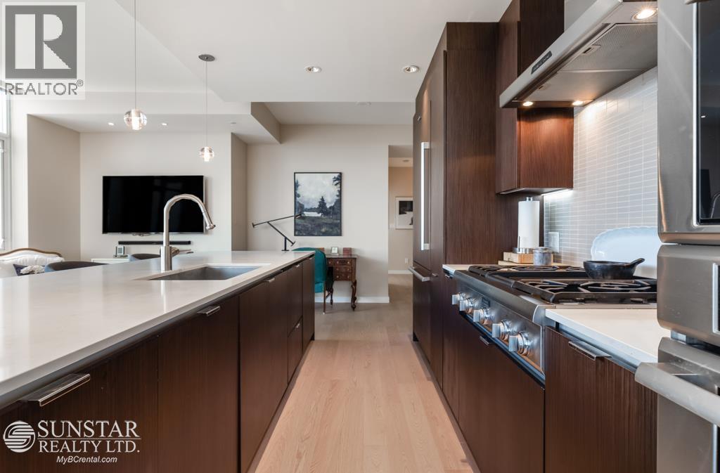 A modern kitchen with wooden cabinets and stainless steel appliances.