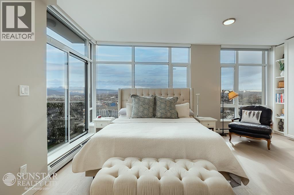 A bedroom with a large bed and a view of the city.