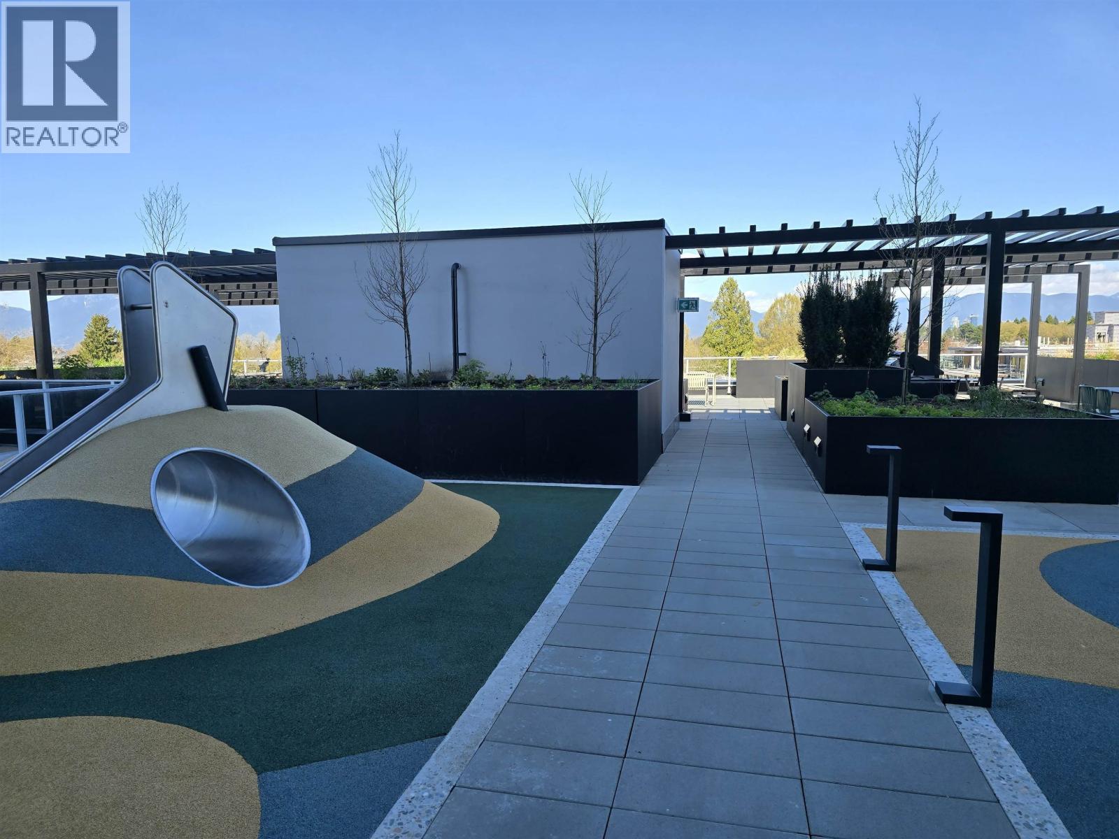 A playground with a slide and a climbing structure.