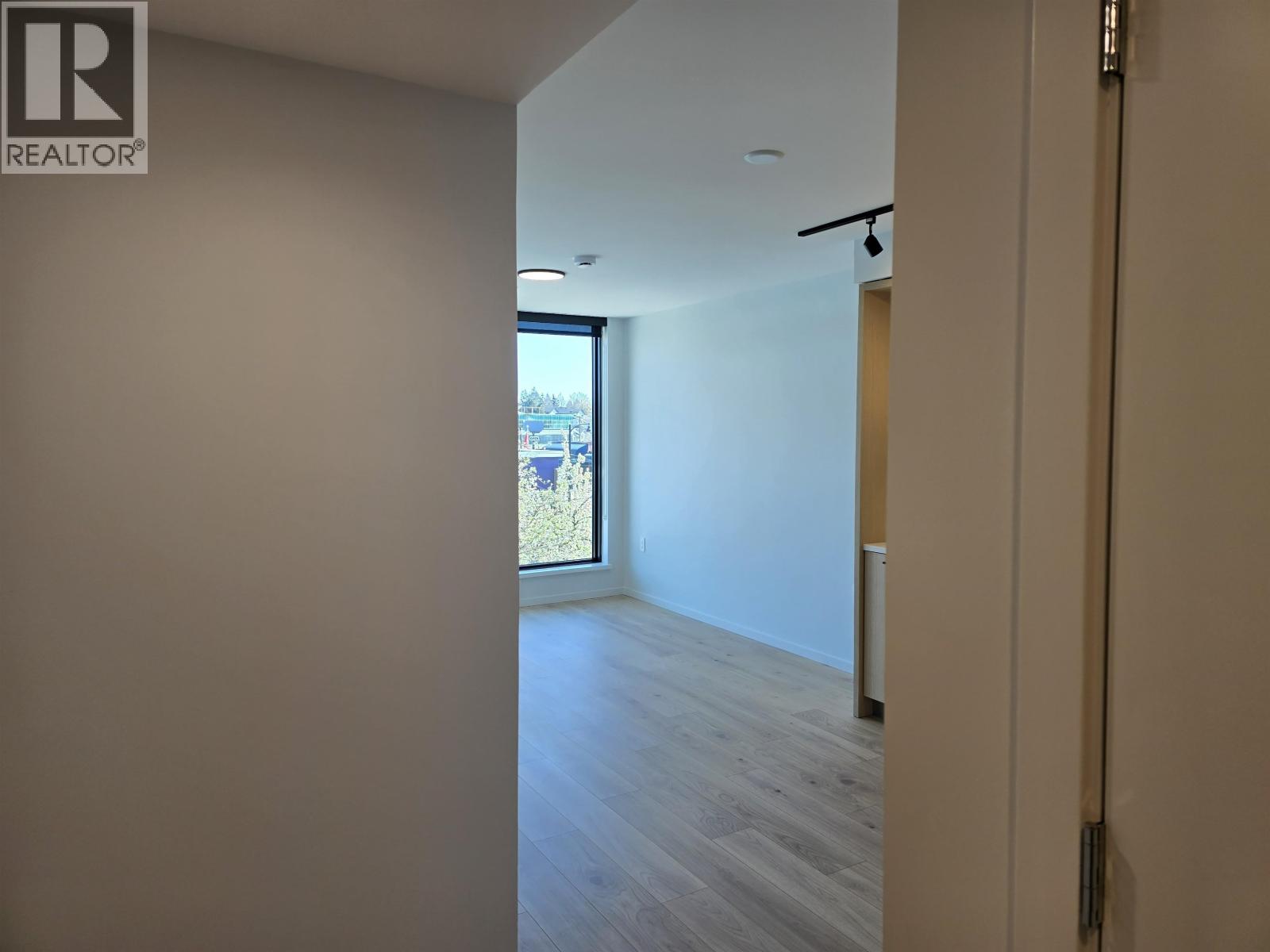 A hallway with a sliding door leading to a balcony.