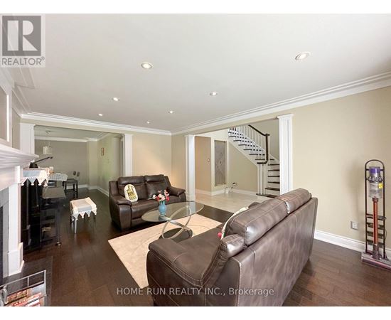 A living room with a brown leather couch and a glass coffee table.