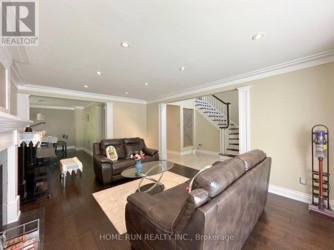 A living room with a brown leather couch and a glass coffee table.