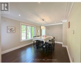 A dining room with a table set for two and a window letting in light.