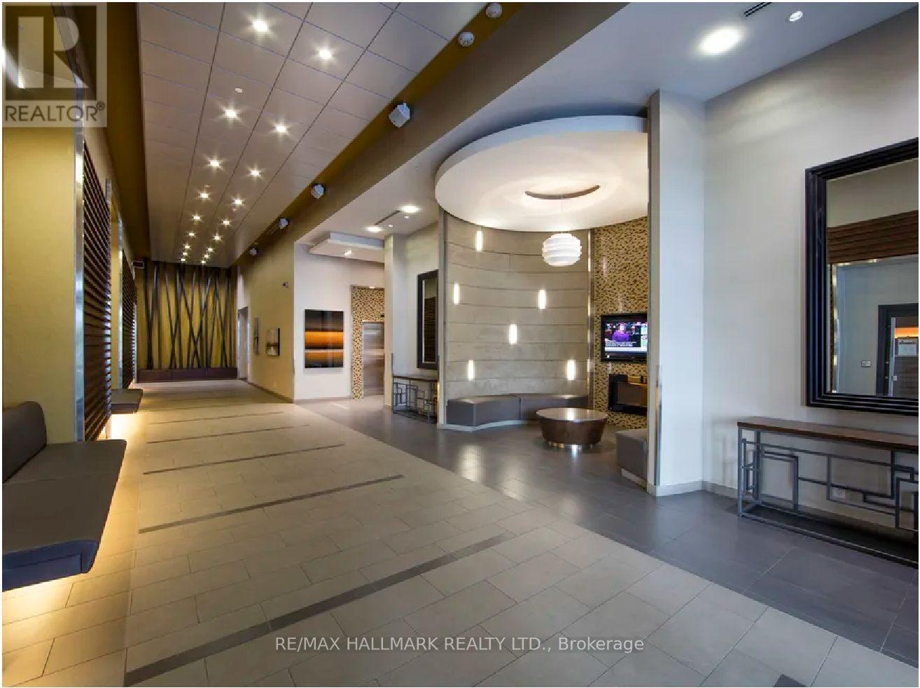 A spacious hallway with a curved ceiling and a reception desk.