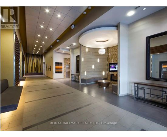 A spacious hallway with a curved ceiling and a reception desk.