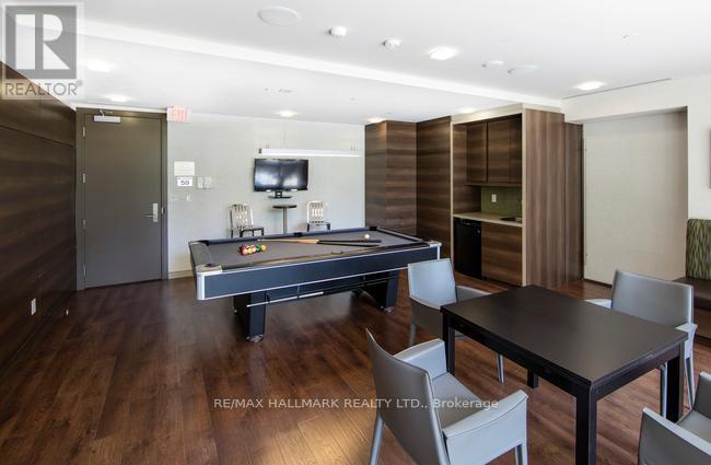 A room with a pool table and a tv.