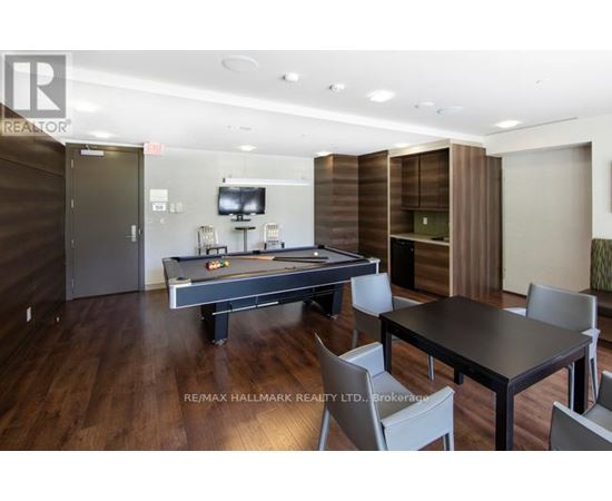 A room with a pool table and a tv.