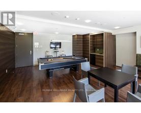A room with a pool table and a tv.