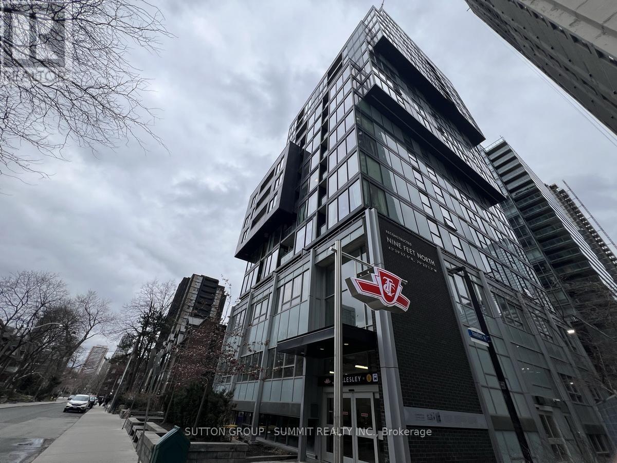 A tall building with a red and white logo on the front.