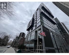 A tall building with a red and white logo on the front.