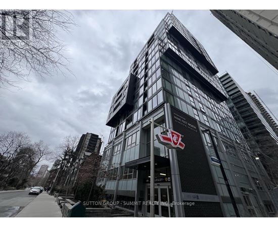 A tall building with a red and white logo on the front.