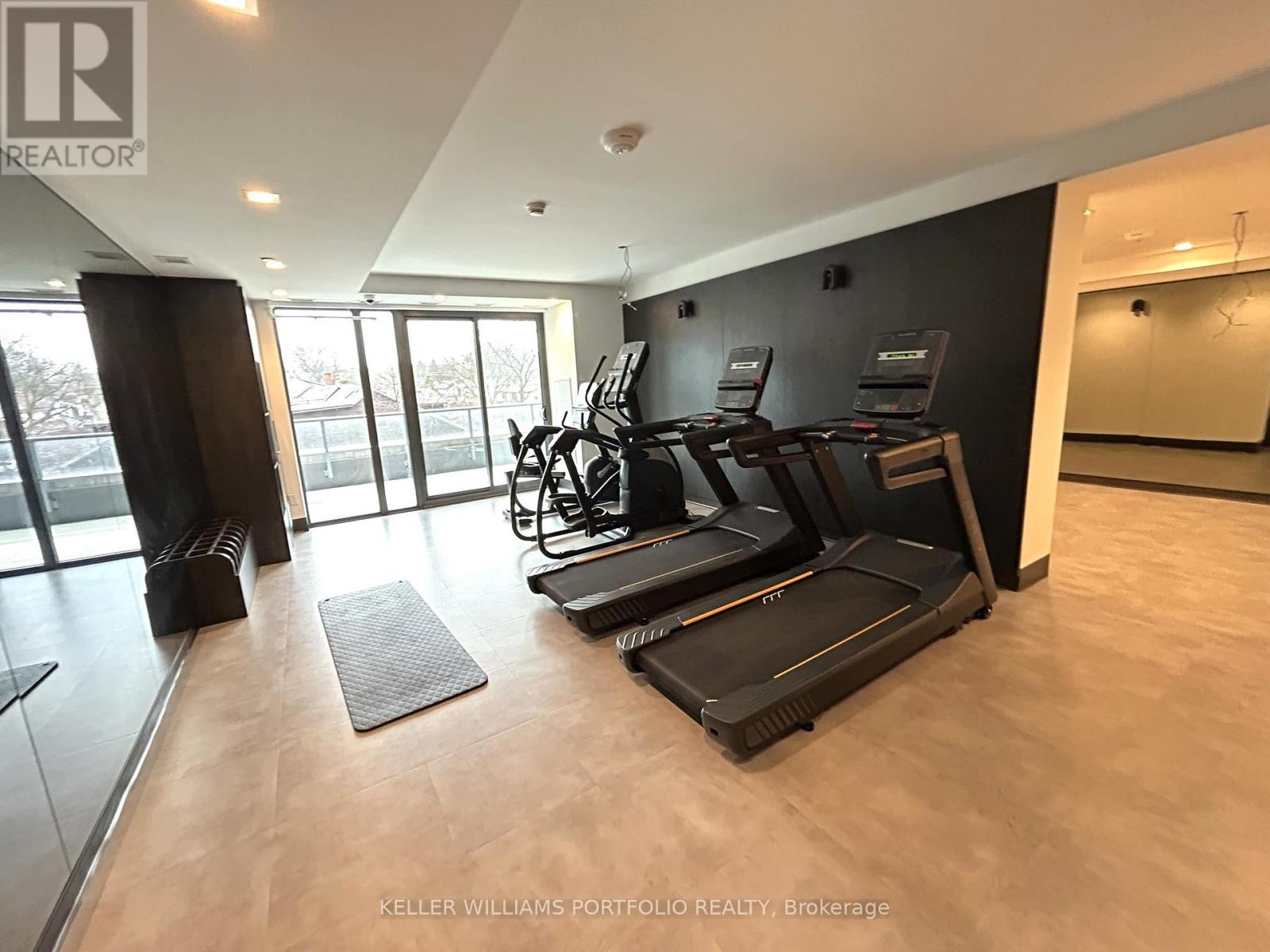 A gym with treadmills and exercise bikes is shown.
