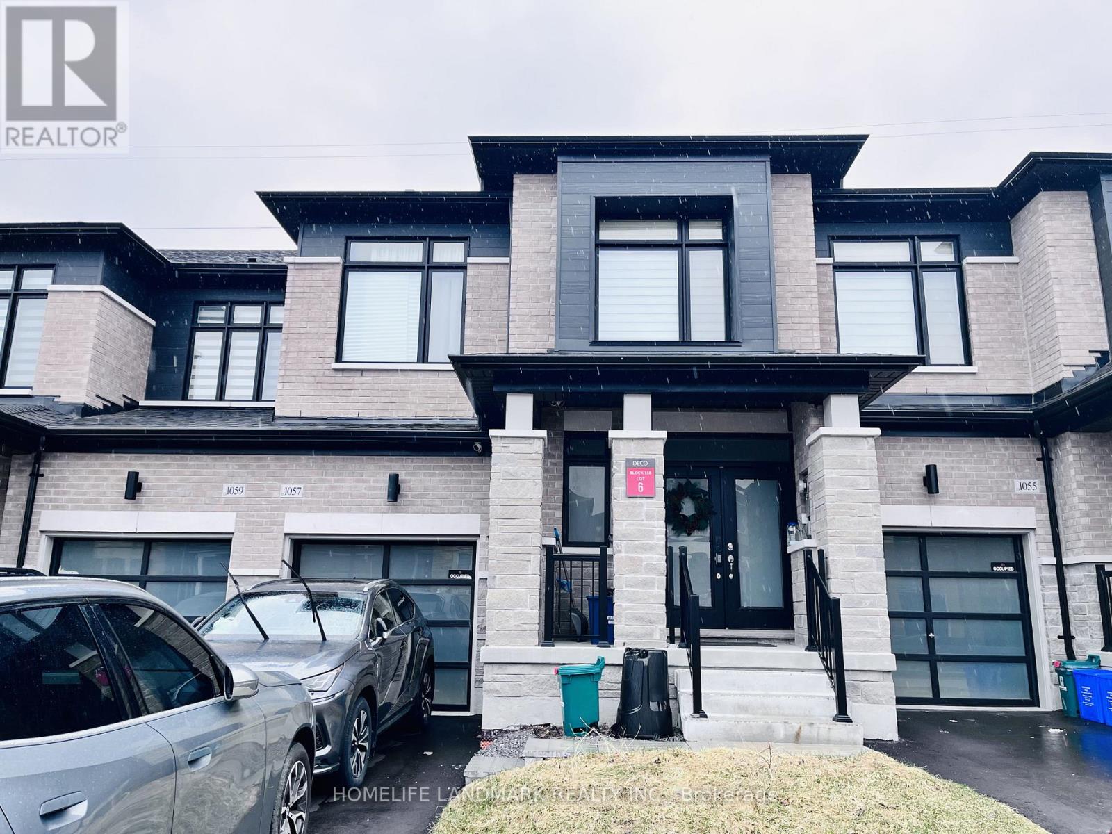 A modern two-story house with a garage and a car parked in front.