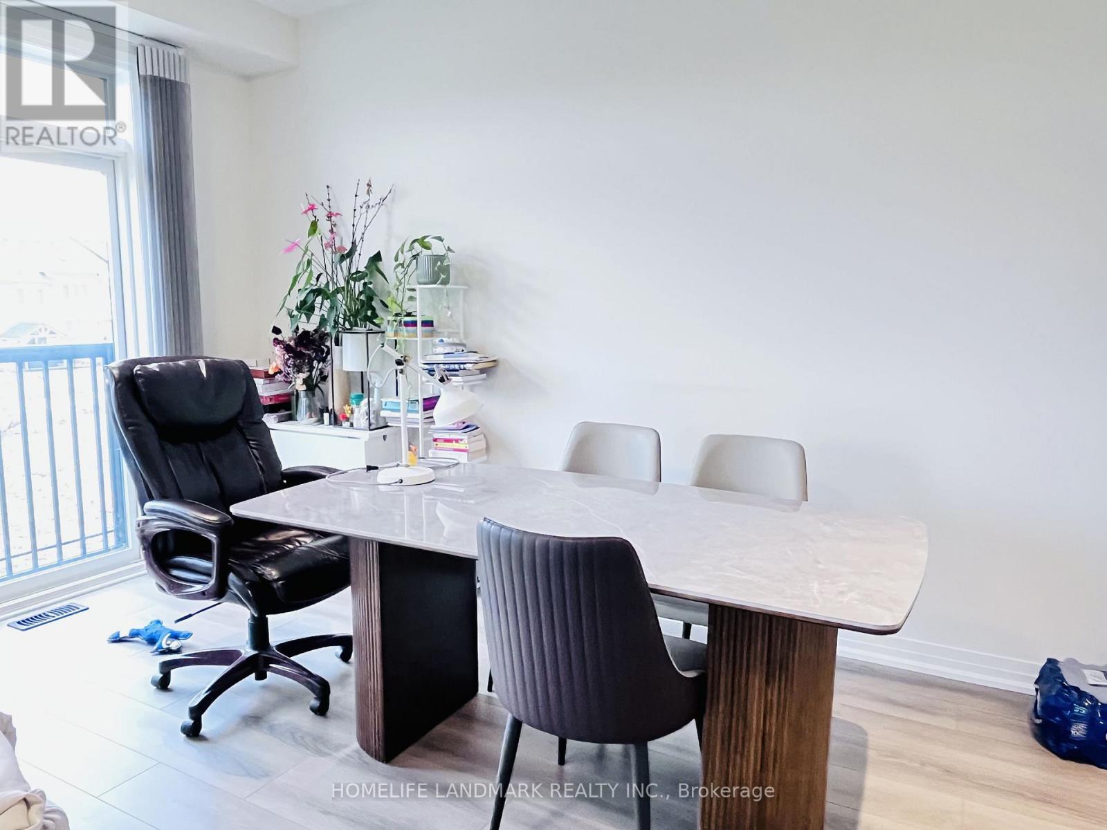 A dining room with a table and chairs.