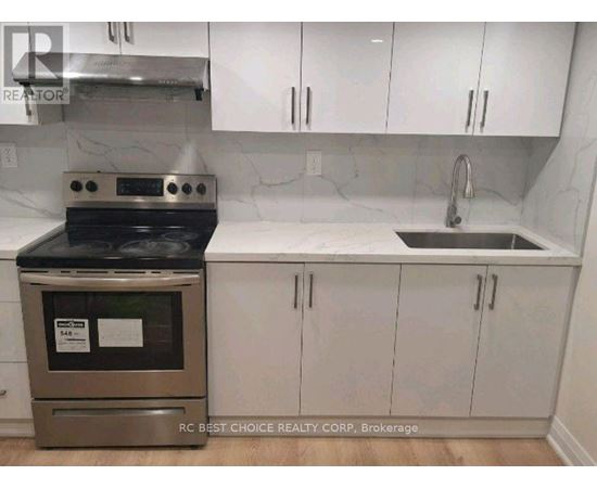 A kitchen with a stove and sink.