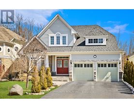 A large house with a red door and two garages.