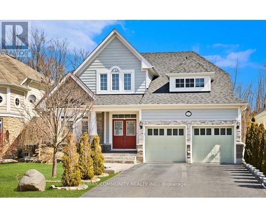 A large house with a red door and two garages.
