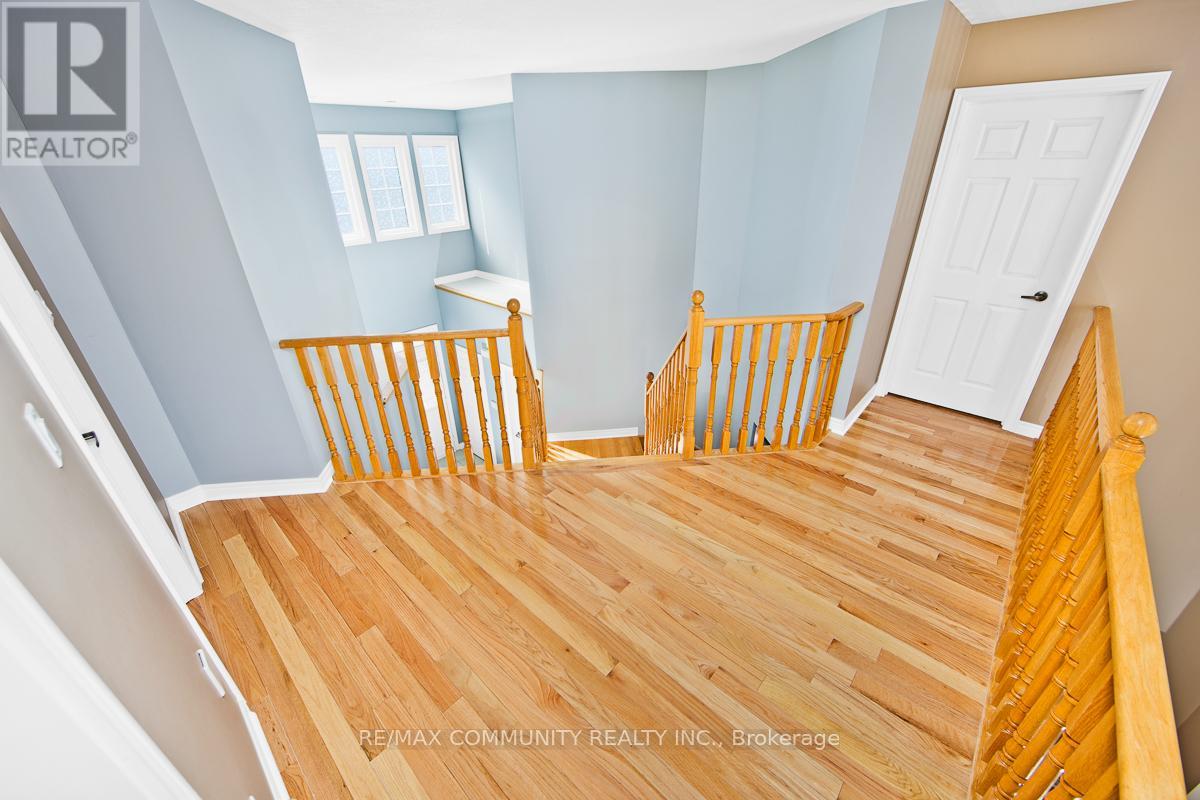A bedroom with a wooden floor and a white door.