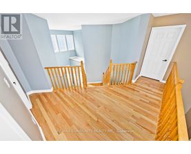 A bedroom with a wooden floor and a white door.
