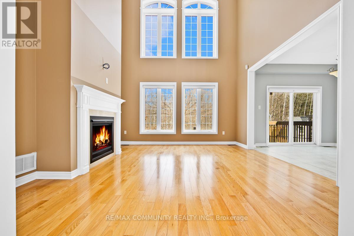 A spacious room with a fireplace and large windows.