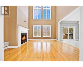 A spacious room with a fireplace and large windows.