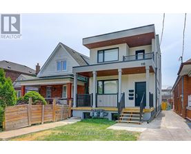 A two-story house with a balcony on the second floor is for sale.