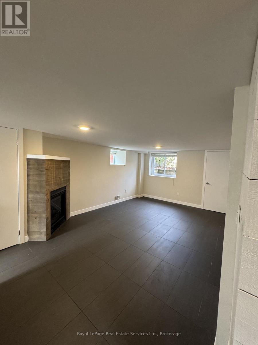 A spacious room with a fireplace and a window.
