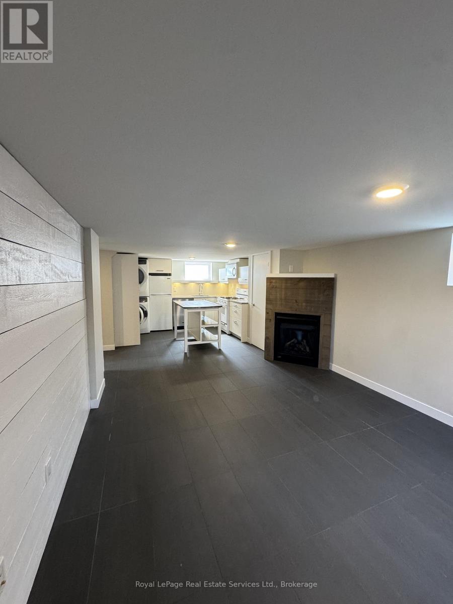 A spacious room with a fireplace and a dining table.
