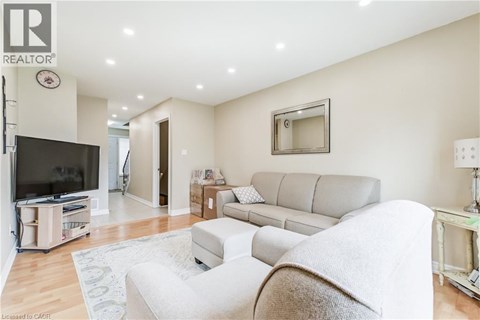 A living room with a grey couch and a television.