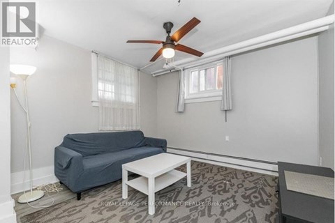 A living room with a blue couch and a white coffee table.