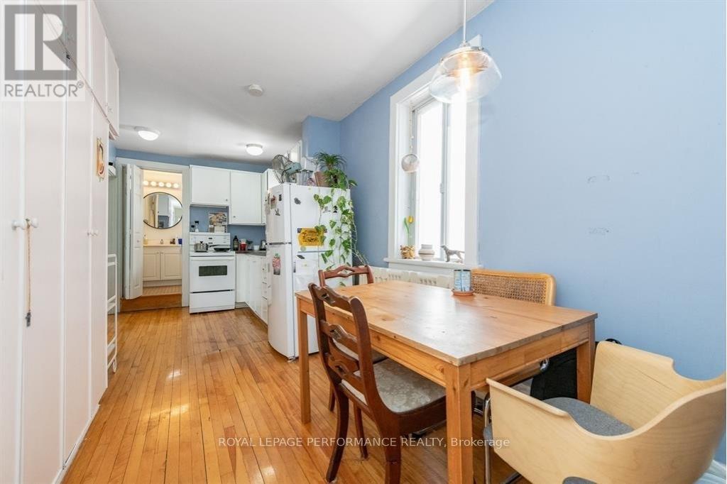 A kitchen with a table and chairs in front of a window.