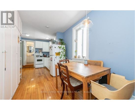 A kitchen with a table and chairs in front of a window.