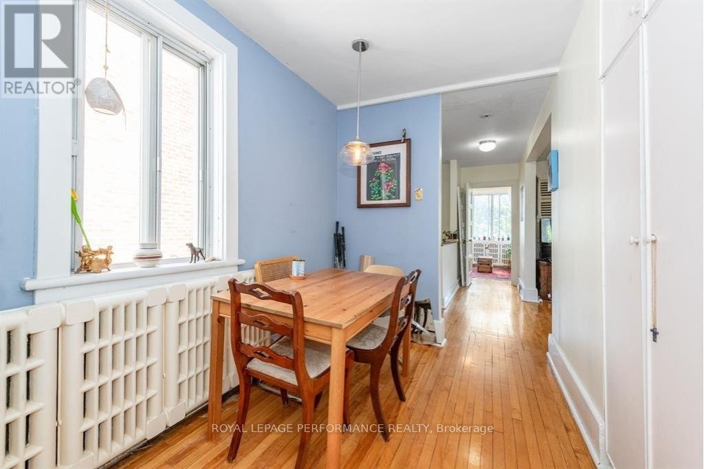 A dining room with a wooden table and chairs.