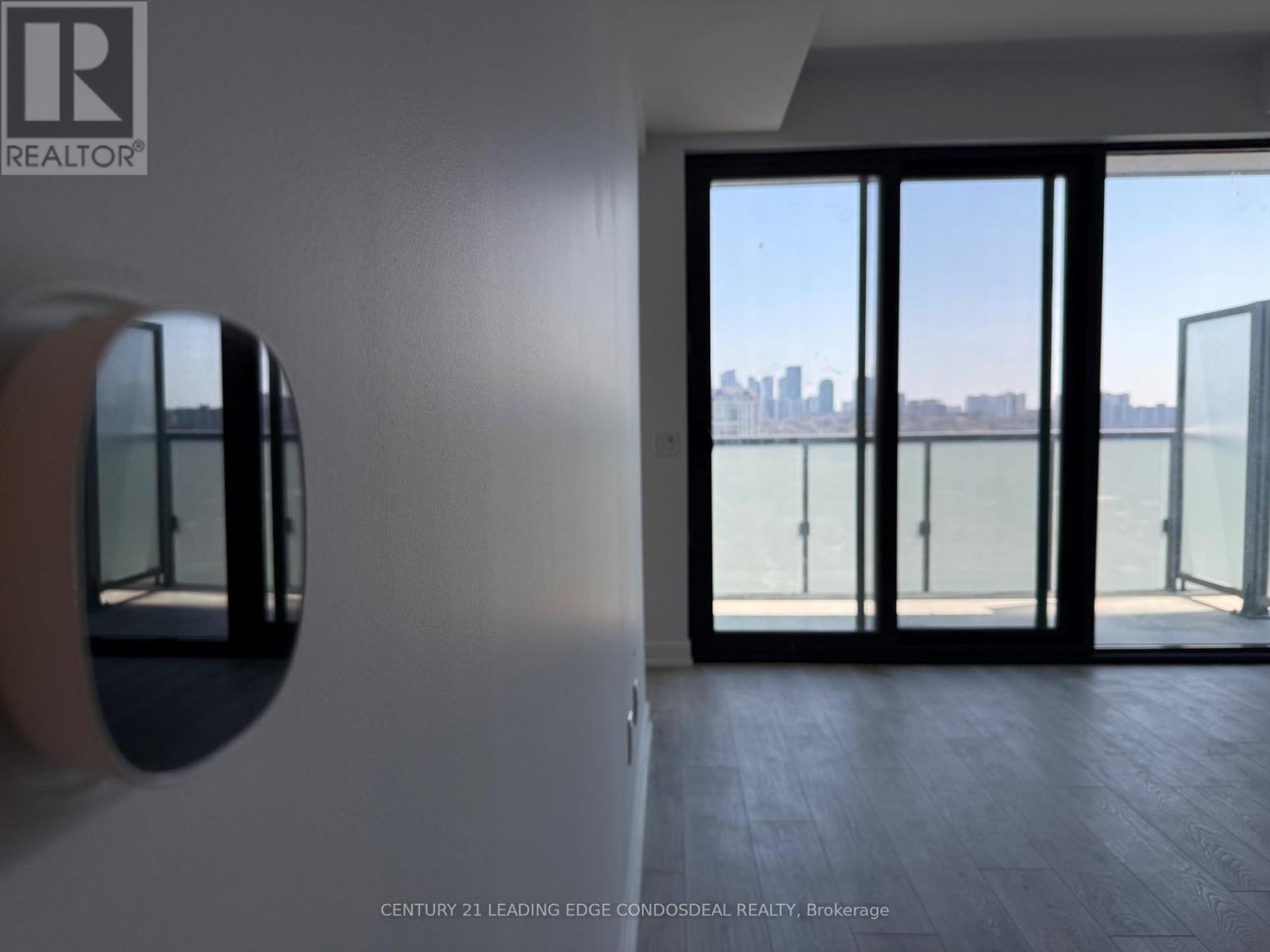 A room with a view of the city through large windows.