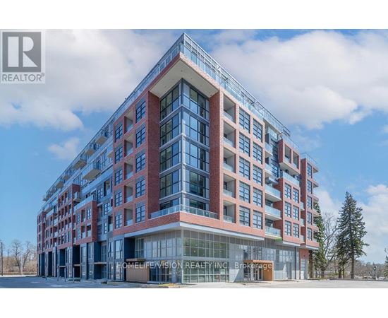 A modern multi-story building with a glass entrance and a sign that reads "HOMELIFE VISION REALTORS".
