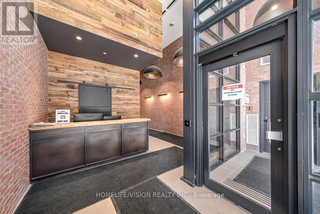 A realtor's office with a brick wall and a black reception desk.