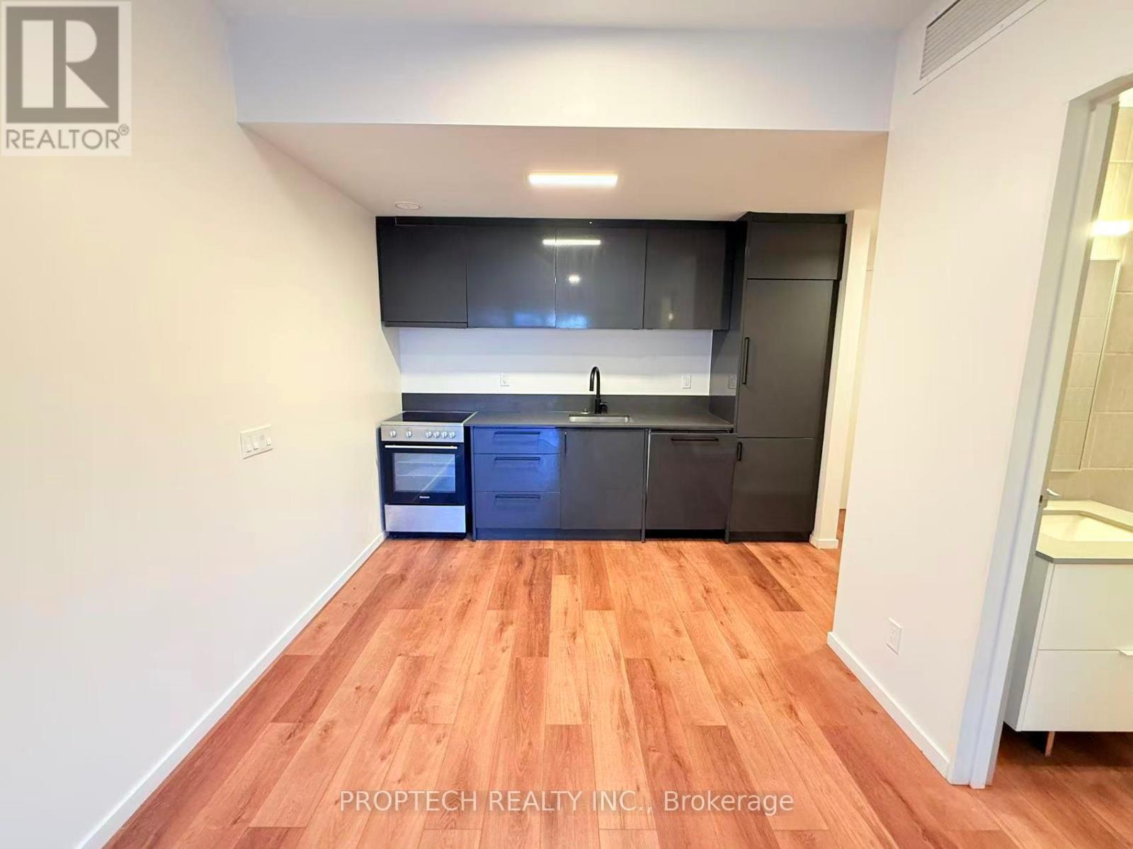 A kitchen with wooden floors and modern appliances.