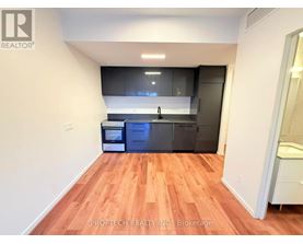 A kitchen with wooden floors and modern appliances.