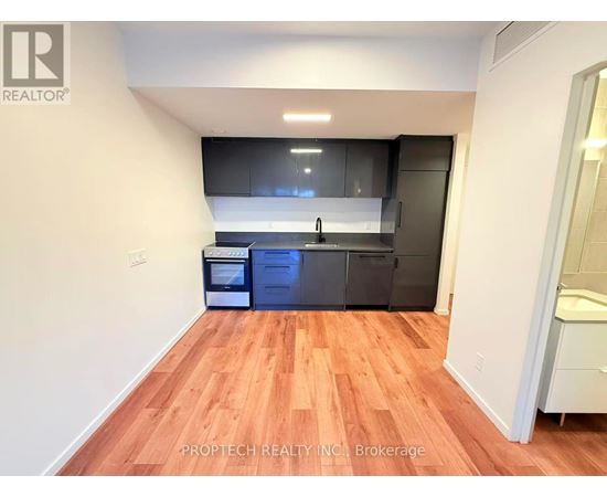 A kitchen with wooden floors and modern appliances.