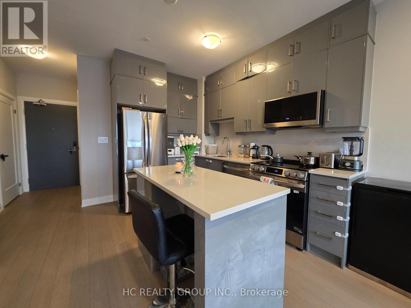 A kitchen with a table and chairs in the middle of it.