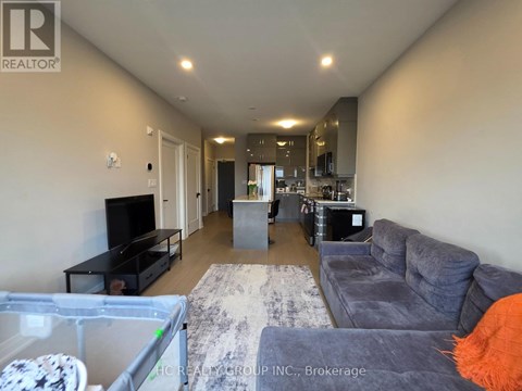 A living room with a grey couch and a television.