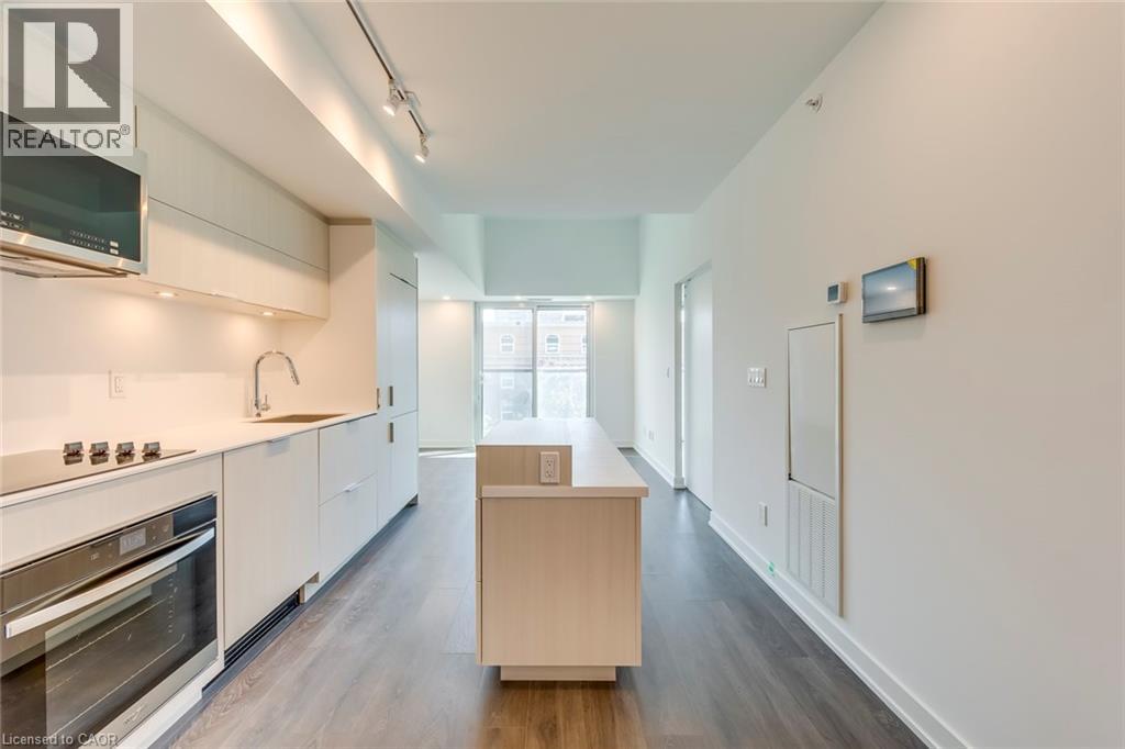 A modern kitchen with white cabinets and stainless steel appliances.