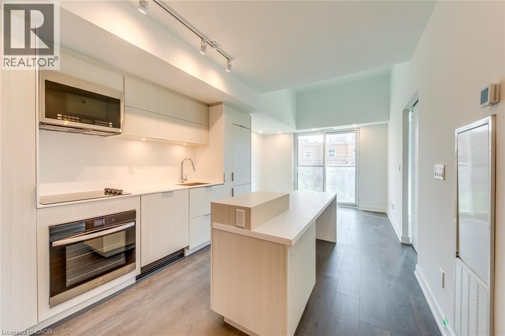 A modern kitchen with white cabinets and stainless steel appliances.