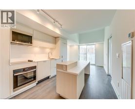 A modern kitchen with white cabinets and stainless steel appliances.