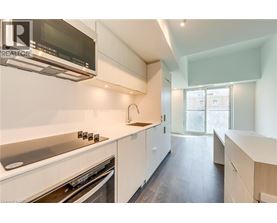A modern kitchen with white cabinets and stainless steel appliances.