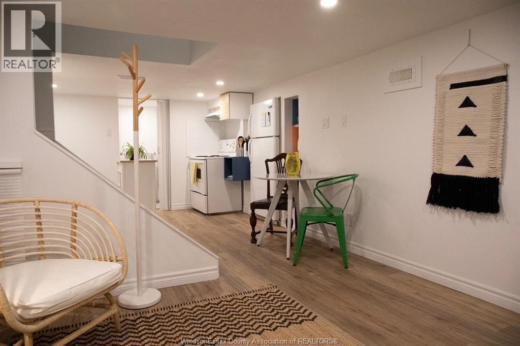 A room with a chair, a table, and a rug.