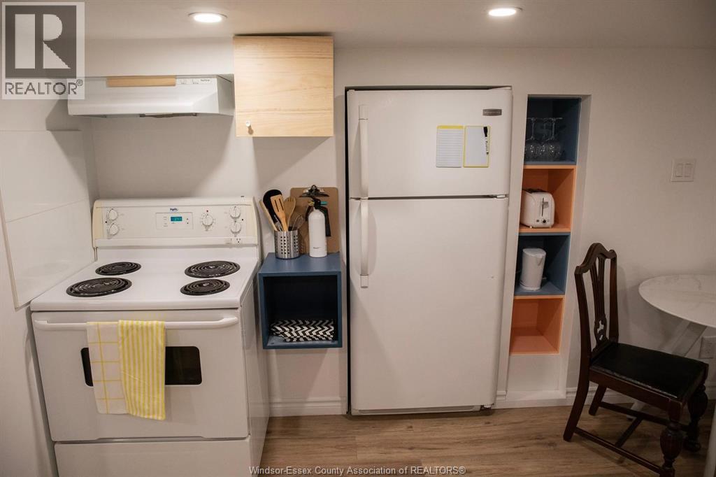 A small kitchen with a white fridge and a white stove.