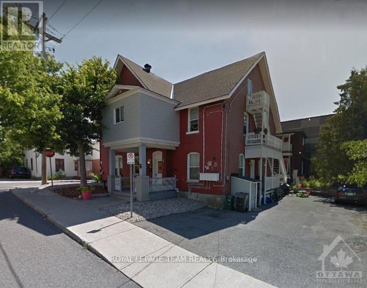 A two-story house with a red and white exterior.