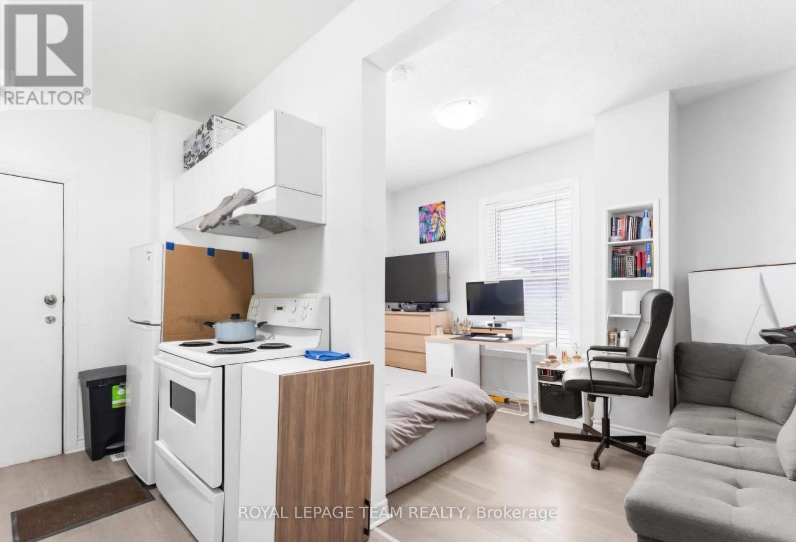 A modern kitchen with a stove top oven and a microwave.