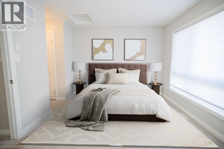 A bedroom with a large bed and two framed pictures on the wall.